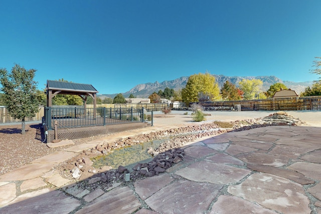 surrounding community featuring a mountain view and a gazebo