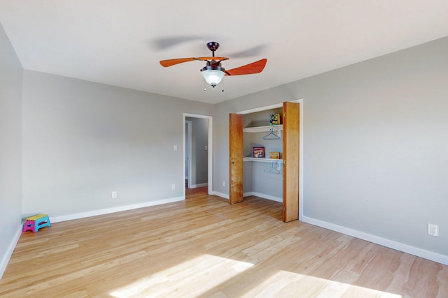 unfurnished bedroom featuring a closet, light hardwood / wood-style flooring, and ceiling fan