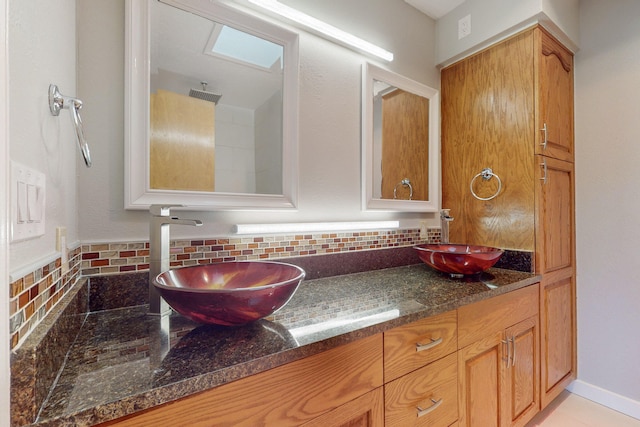 bathroom featuring decorative backsplash and vanity