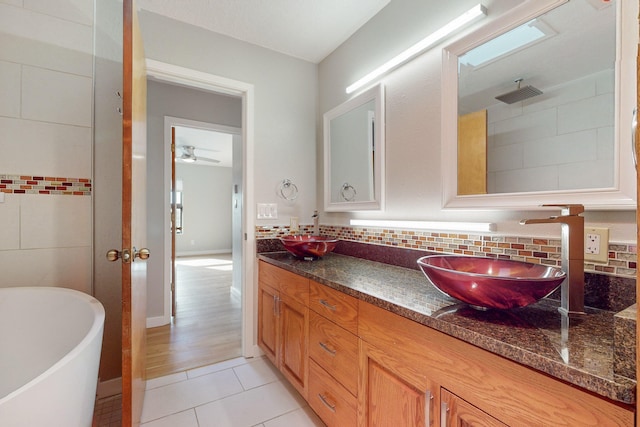 bathroom featuring ceiling fan, decorative backsplash, vanity, independent shower and bath, and hardwood / wood-style flooring