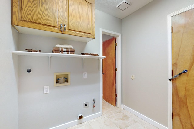 laundry room with cabinets, hookup for a washing machine, gas dryer hookup, electric dryer hookup, and light tile patterned flooring