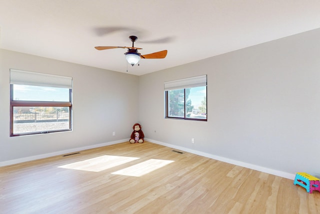 empty room with light wood-type flooring and ceiling fan