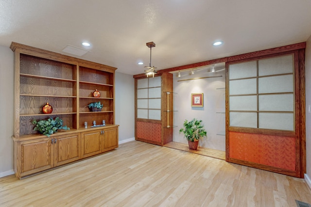 interior space with french doors and light hardwood / wood-style flooring