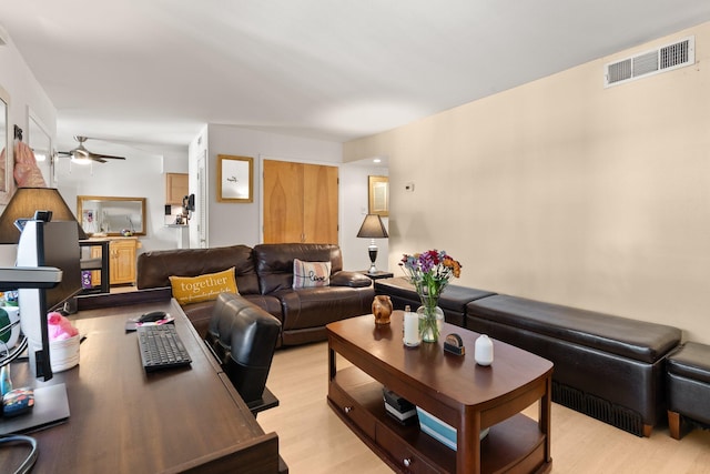 living room with ceiling fan and light wood-type flooring