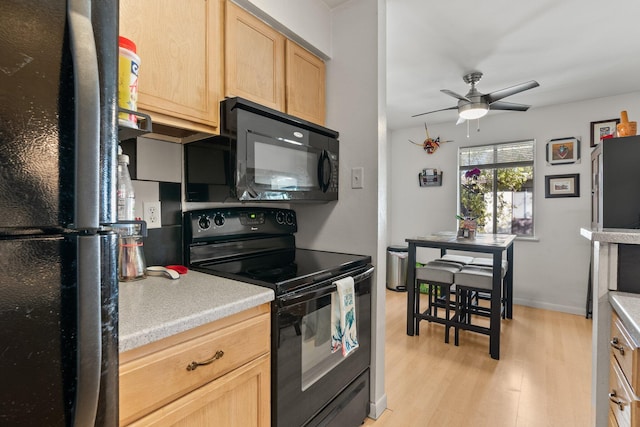 kitchen featuring ceiling fan, light hardwood / wood-style flooring, black appliances, and light brown cabinets