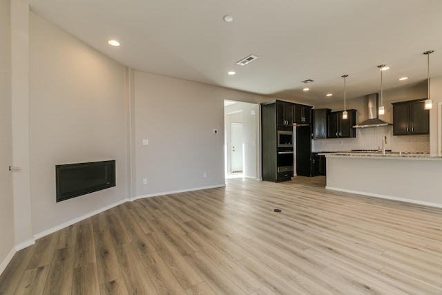 unfurnished living room featuring light wood-type flooring