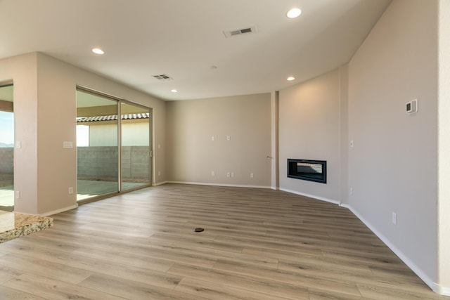 unfurnished living room with light hardwood / wood-style flooring