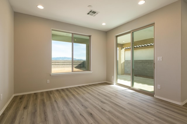 empty room with hardwood / wood-style floors and a mountain view