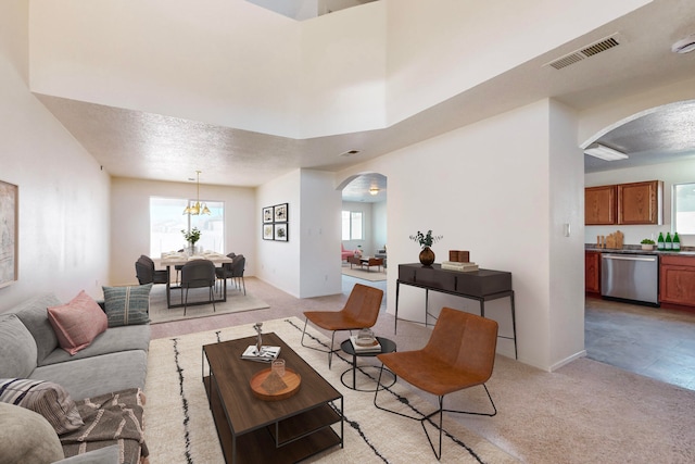 living room featuring a textured ceiling and light colored carpet