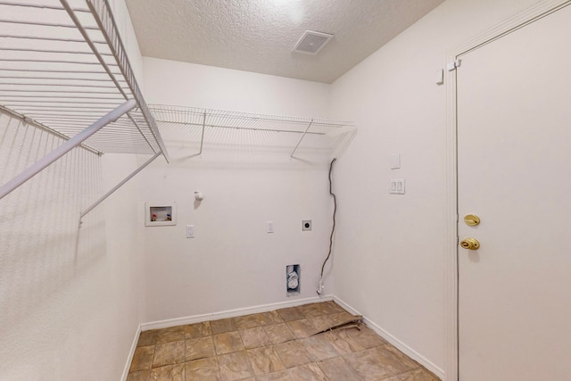 laundry area featuring washer hookup, a textured ceiling, gas dryer hookup, and electric dryer hookup