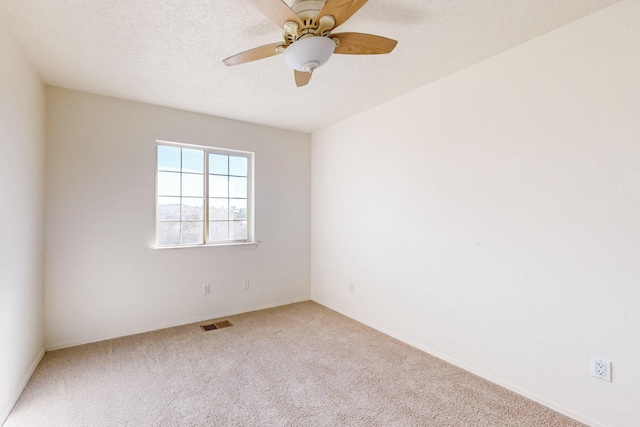 unfurnished room featuring carpet, ceiling fan, and a textured ceiling