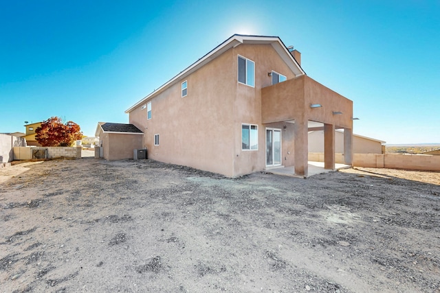 back of property featuring central AC