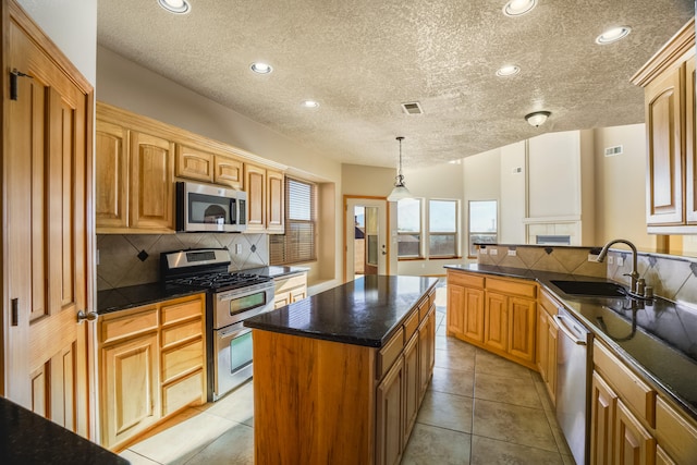 kitchen with sink, stainless steel appliances, backsplash, pendant lighting, and light tile patterned flooring