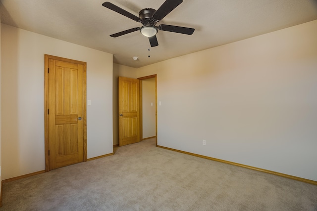 unfurnished bedroom with light carpet and ceiling fan