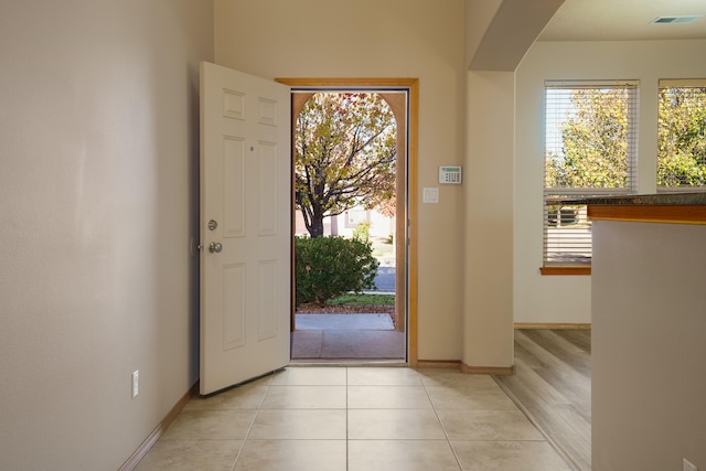 entrance foyer featuring light tile patterned floors and a wealth of natural light