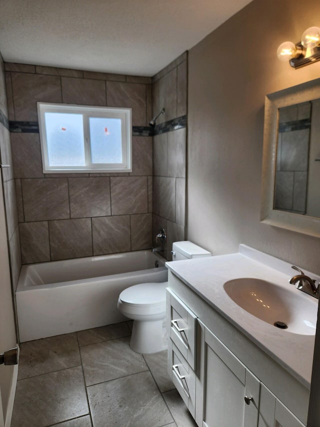 full bathroom featuring vanity, toilet, and tiled shower / bath