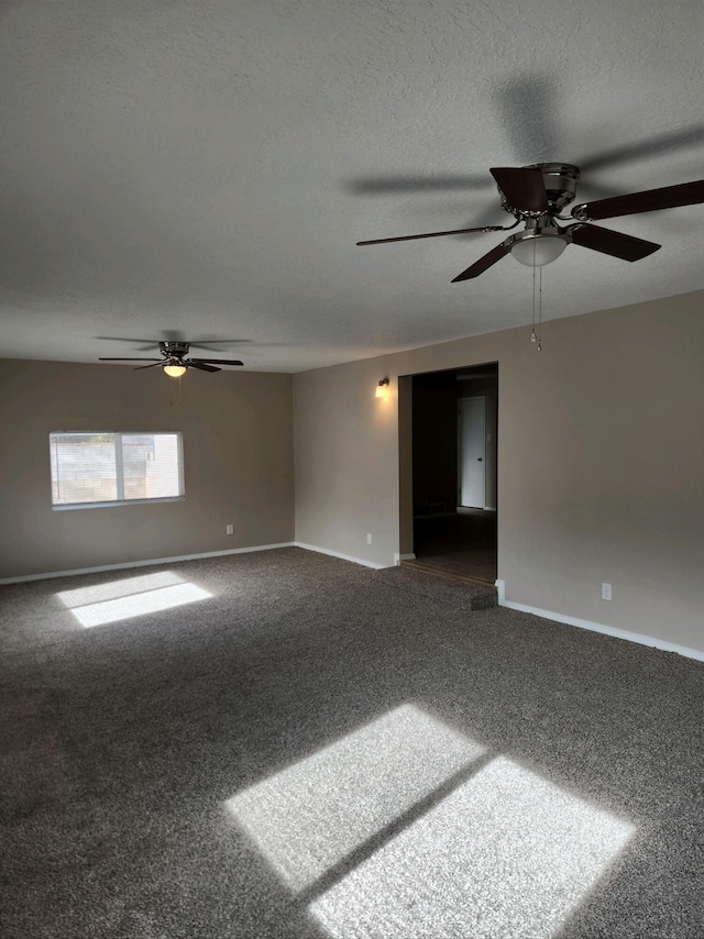 carpeted spare room featuring a textured ceiling and ceiling fan