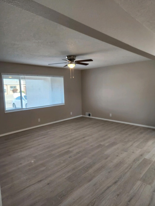 unfurnished room with ceiling fan and wood-type flooring