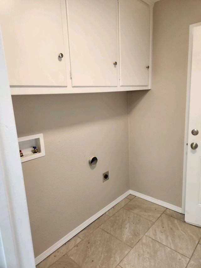 washroom with hookup for an electric dryer, cabinets, and washer hookup