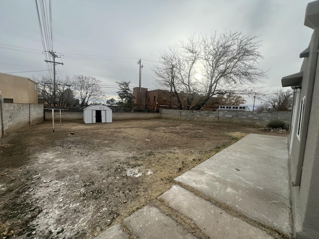 view of yard featuring a patio area and a shed