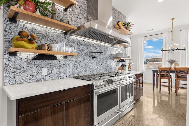 kitchen with dark brown cabinetry, an inviting chandelier, island exhaust hood, double oven range, and decorative light fixtures