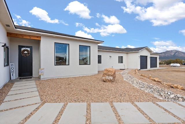 view of front of home featuring a mountain view and a garage