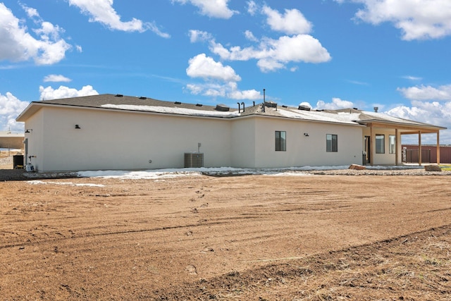 back of property featuring central AC