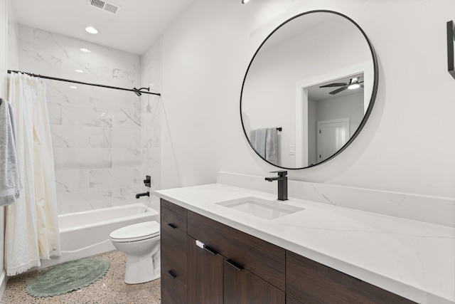 full bathroom featuring ceiling fan, toilet, shower / bath combo with shower curtain, and vanity