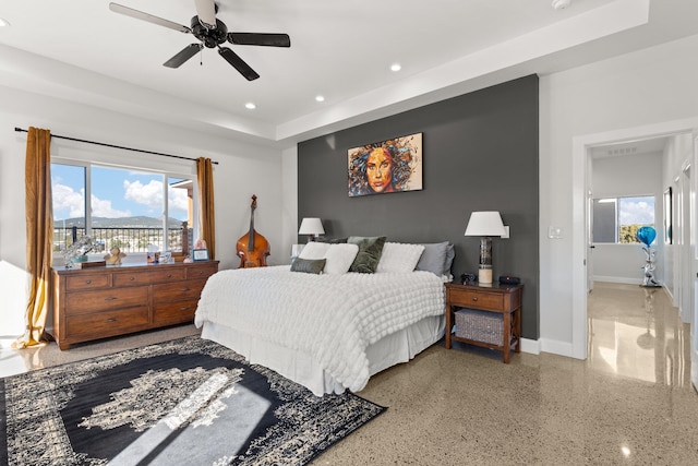 bedroom with multiple windows and ceiling fan