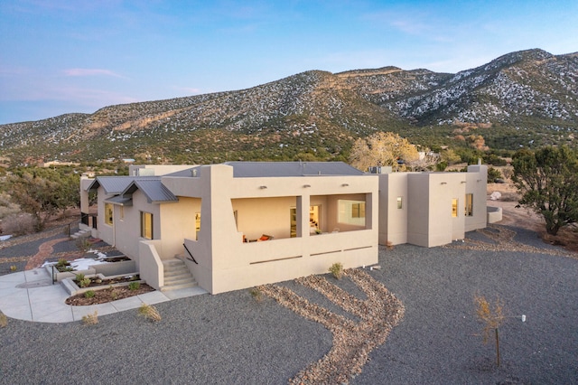 pueblo revival-style home with a mountain view