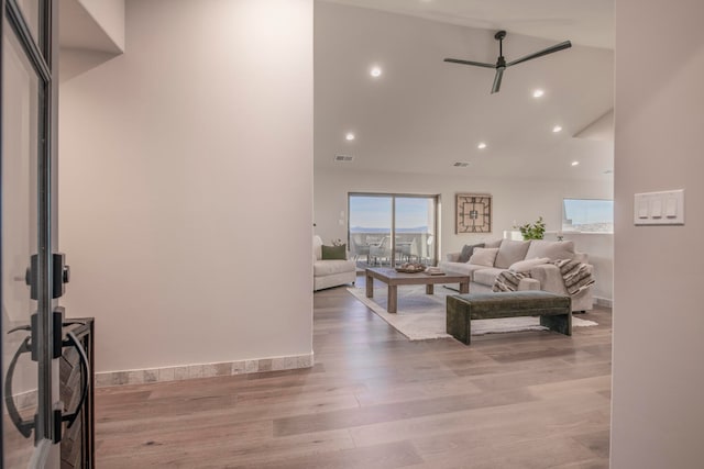 living room featuring ceiling fan and light hardwood / wood-style floors