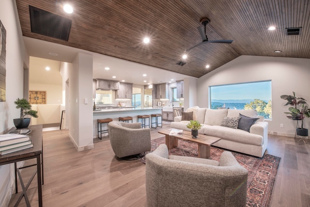 living room featuring wood ceiling, ceiling fan, light hardwood / wood-style floors, and lofted ceiling