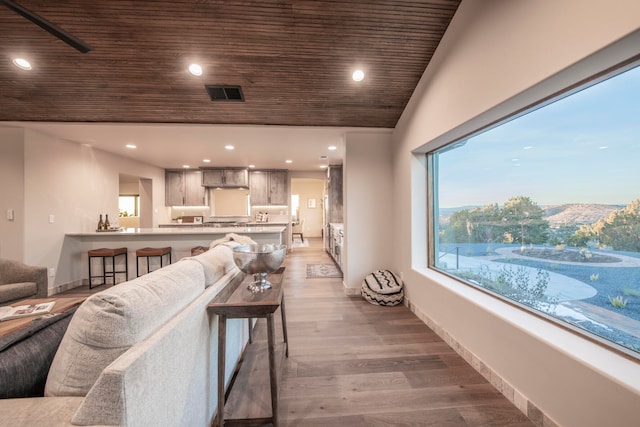 living room featuring hardwood / wood-style flooring, lofted ceiling, and wood ceiling