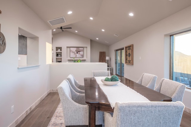 dining room with hardwood / wood-style flooring, ceiling fan, and vaulted ceiling