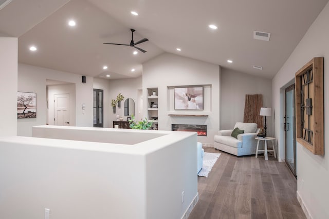 hallway with lofted ceiling and hardwood / wood-style flooring