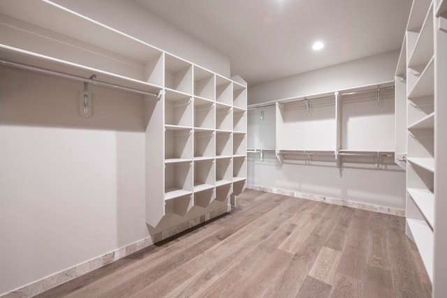 spacious closet featuring hardwood / wood-style floors