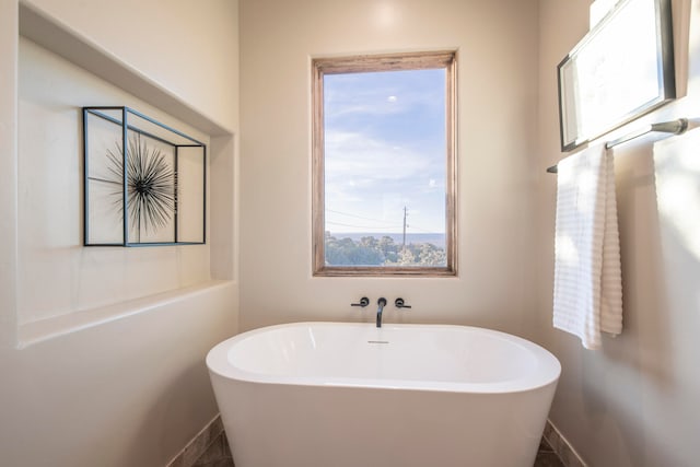 bathroom with a washtub and a wealth of natural light