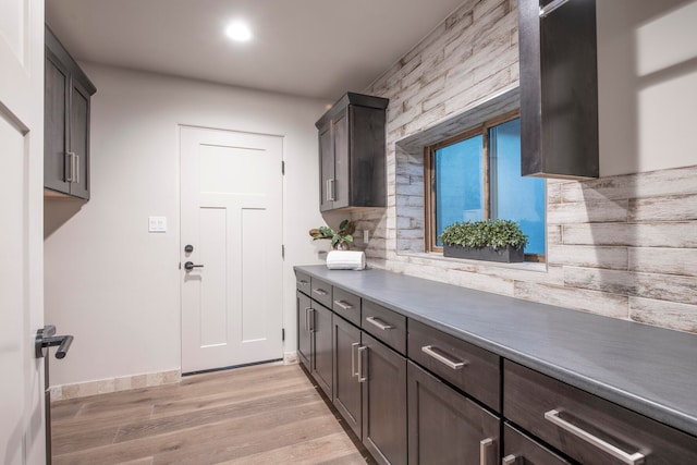 kitchen featuring dark brown cabinets and light hardwood / wood-style floors