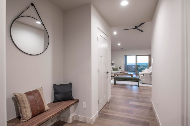 corridor with light hardwood / wood-style floors