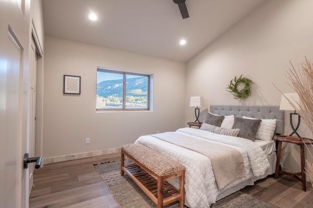 bedroom featuring ceiling fan, dark hardwood / wood-style flooring, and lofted ceiling