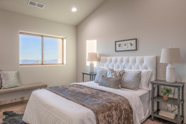 bedroom with hardwood / wood-style flooring and vaulted ceiling