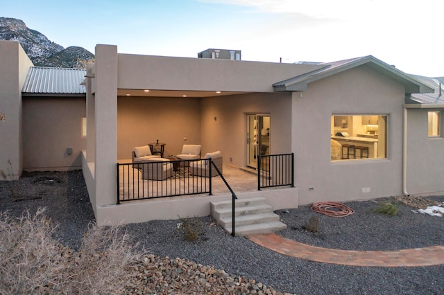 view of front facade featuring outdoor lounge area and a mountain view