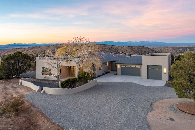 view of front of house featuring a mountain view and a garage