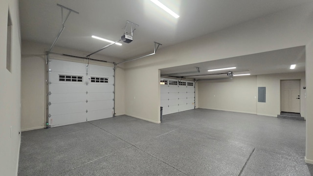 garage featuring electric panel and a garage door opener