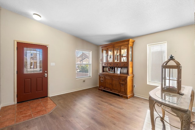 foyer featuring light hardwood / wood-style floors and a textured ceiling