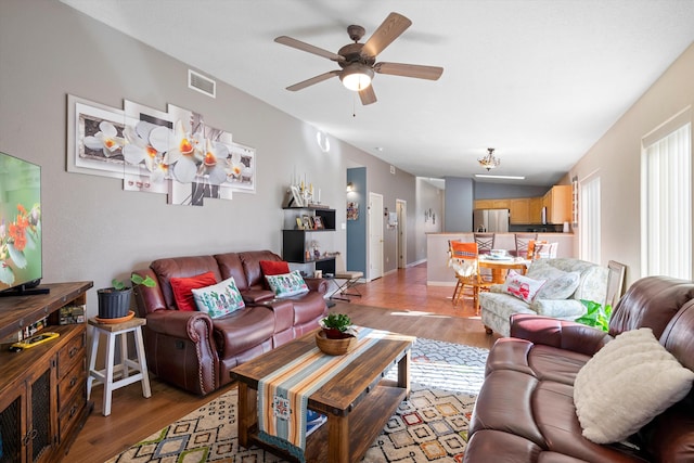 living room with ceiling fan and light wood-type flooring