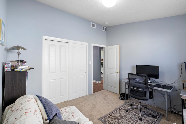 office space featuring carpet and a textured ceiling