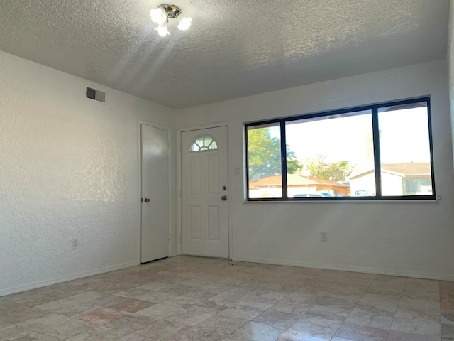 entryway with a textured ceiling