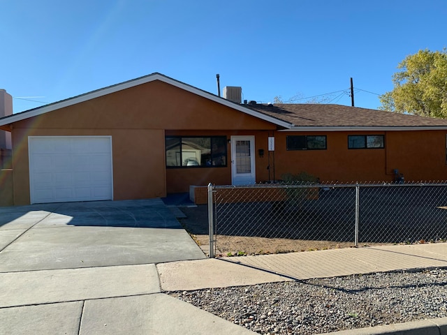 ranch-style house with a garage and central AC