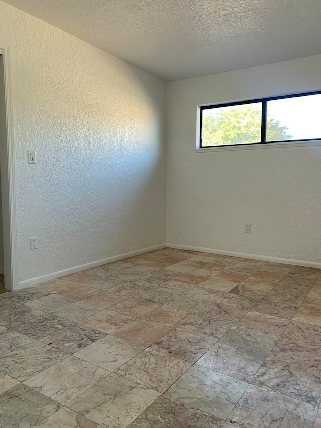 empty room with a textured ceiling